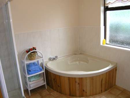main bathroom of the holiday cottage featuring corner bath